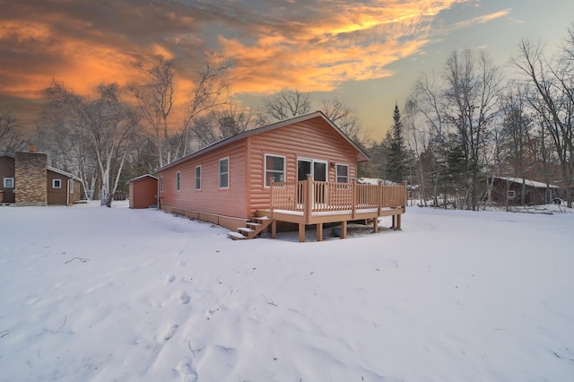 exterior space featuring a wooden deck and a storage shed