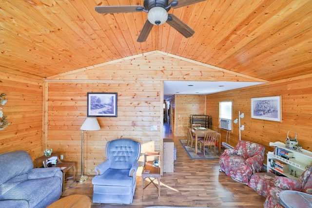 living area featuring wood ceiling, a ceiling fan, wood walls, wood finished floors, and lofted ceiling