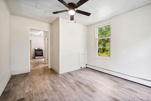 spare room with ceiling fan, a paneled ceiling, light wood-type flooring, and a baseboard heating unit