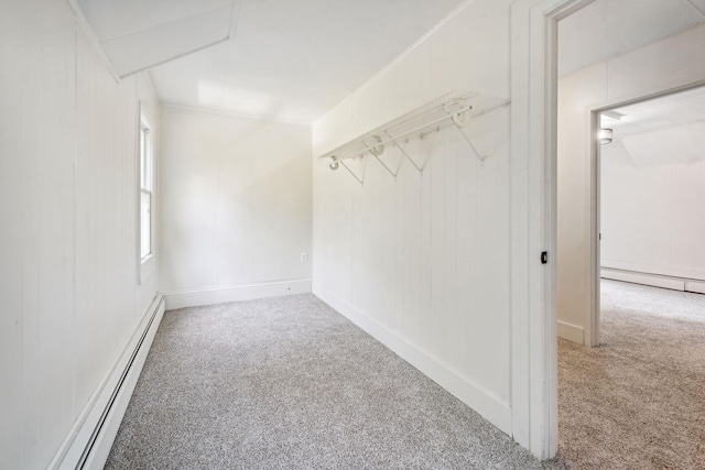 walk in closet with baseboard heating and carpet