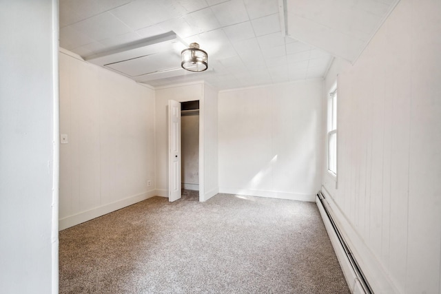 spare room featuring a baseboard radiator and carpet floors