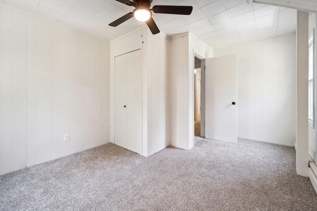 unfurnished bedroom featuring carpet flooring, ceiling fan, and a closet