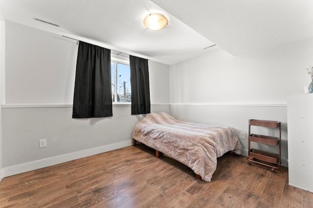 bedroom with hardwood / wood-style flooring