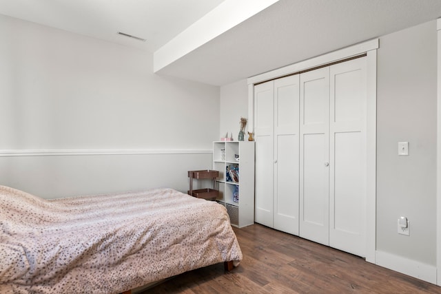 bedroom featuring a closet and dark hardwood / wood-style flooring