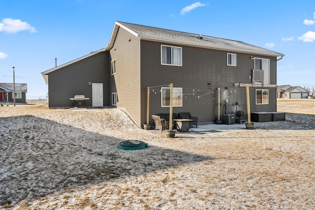 back of property with a patio