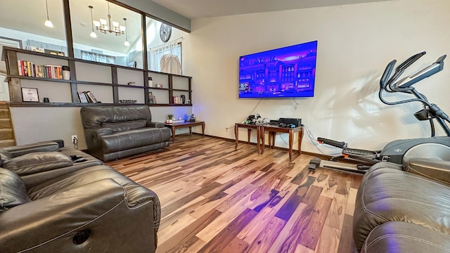 living room with vaulted ceiling, a chandelier, and hardwood / wood-style floors