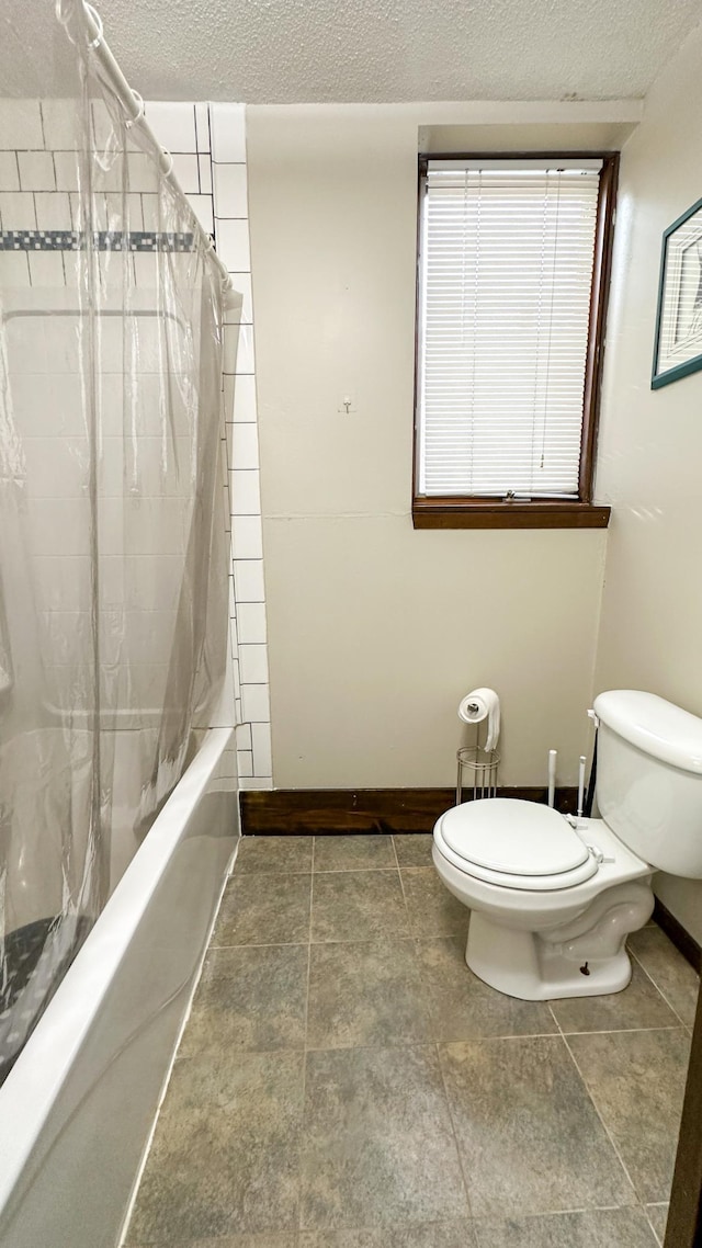 bathroom featuring a textured ceiling, toilet, and shower / bathtub combination with curtain