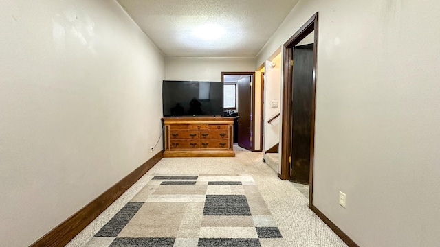 hallway with a textured ceiling