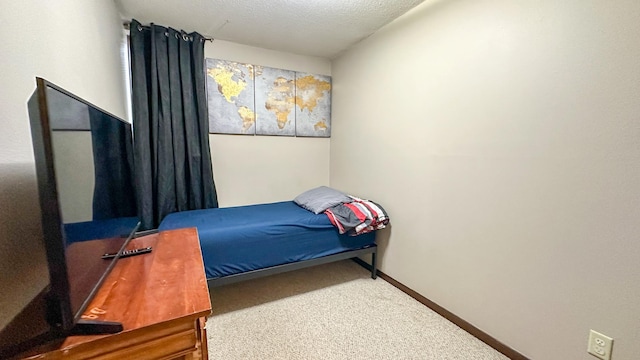 bedroom with a textured ceiling and carpet flooring