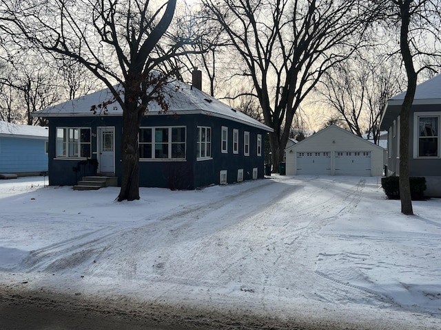 view of front of home with a garage and an outdoor structure