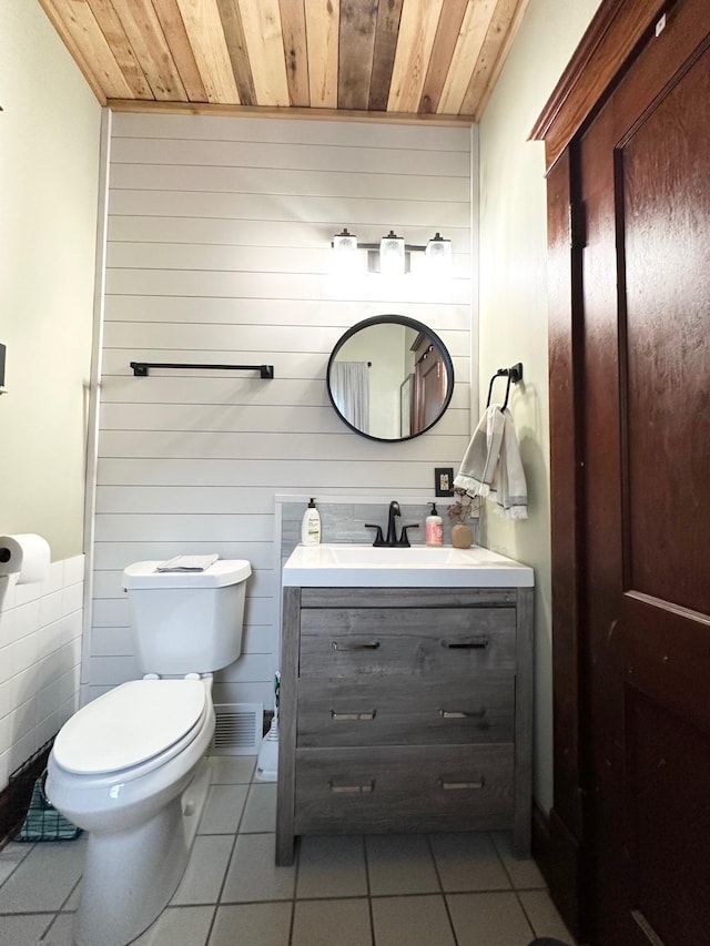 bathroom featuring toilet, wooden ceiling, tile patterned flooring, and vanity