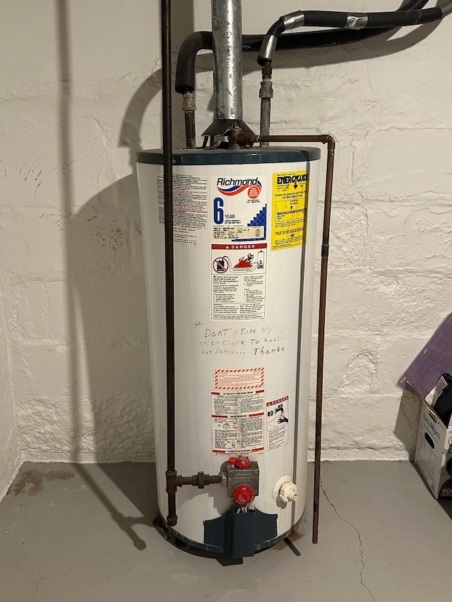 utility room featuring gas water heater