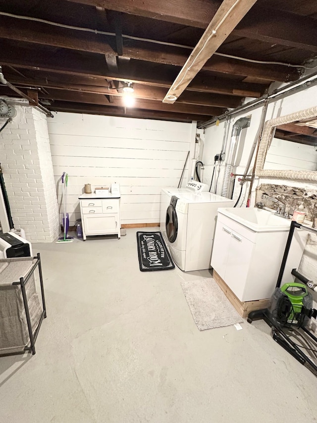 clothes washing area with washing machine and dryer