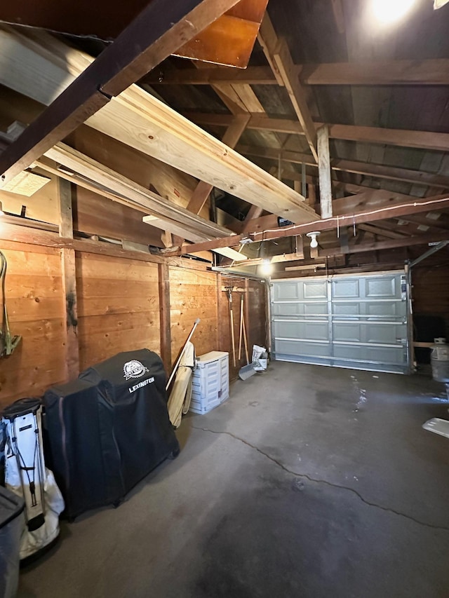 garage featuring wood walls