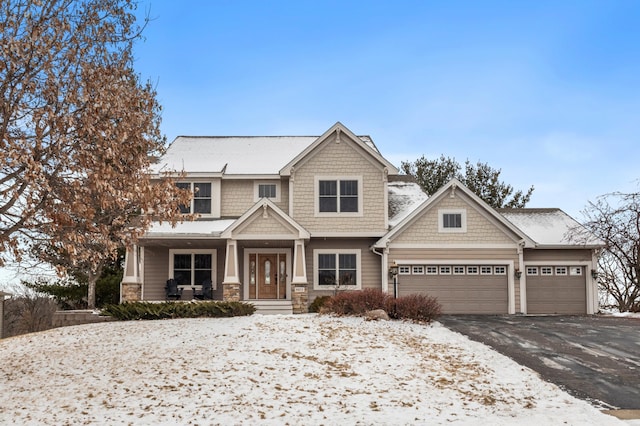 craftsman inspired home with a garage and covered porch