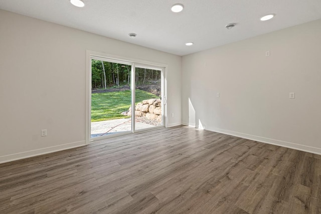 spare room featuring dark wood-type flooring