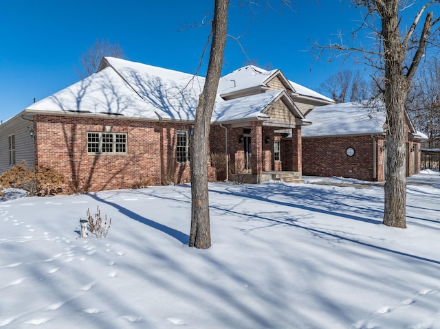 view of front of property featuring covered porch and brick siding