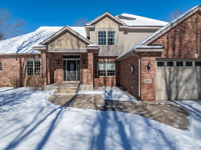 craftsman-style house with brick siding and an attached garage