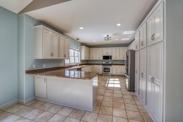 kitchen featuring light tile patterned floors, appliances with stainless steel finishes, decorative light fixtures, a peninsula, and recessed lighting