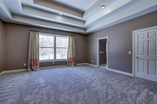 rec room featuring carpet floors, a tray ceiling, and baseboards