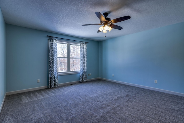 spare room featuring carpet floors, a textured ceiling, baseboards, and a ceiling fan