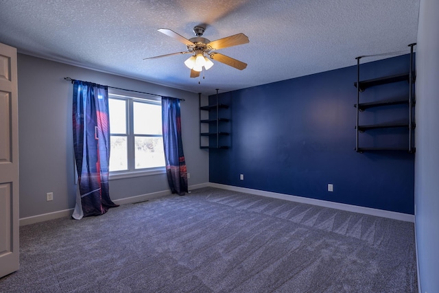 unfurnished room featuring a textured ceiling, carpet floors, a ceiling fan, and baseboards