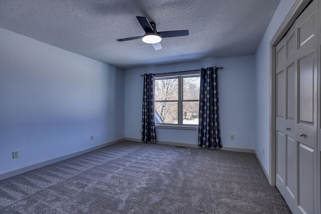 unfurnished bedroom with carpet, ceiling fan, and baseboards