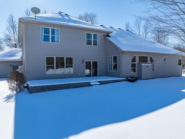 snow covered house with a patio area