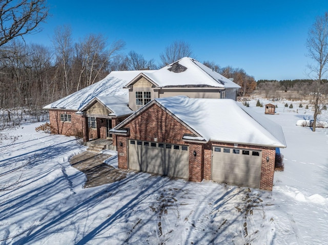 view of front of home featuring brick siding and an attached garage