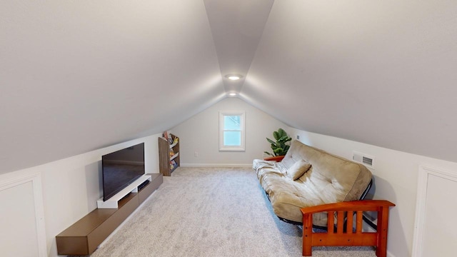 interior space featuring light colored carpet and lofted ceiling