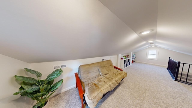 sitting room with carpet floors and lofted ceiling