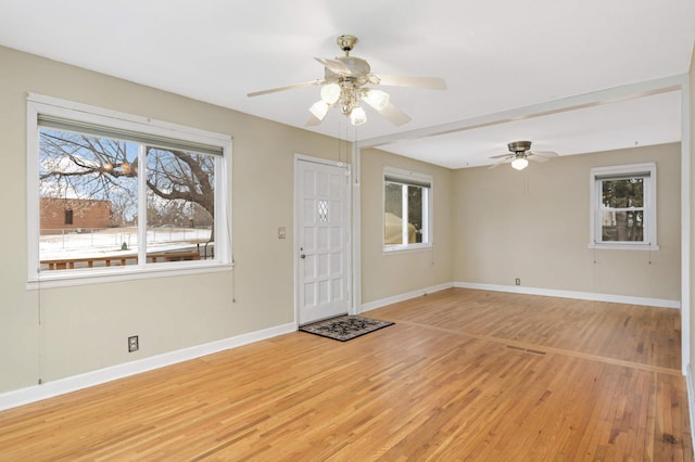 foyer entrance featuring ceiling fan and light wood-type flooring