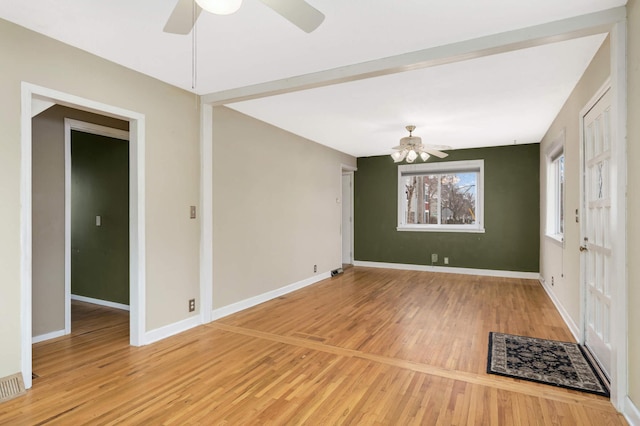 spare room featuring hardwood / wood-style floors and ceiling fan