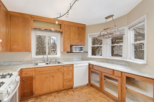 kitchen featuring sink, white appliances, and light parquet flooring