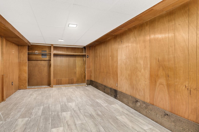 spacious closet with a drop ceiling and light hardwood / wood-style floors