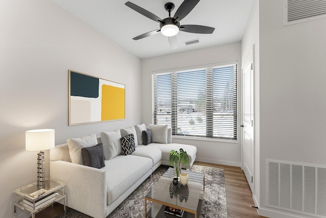 living room featuring hardwood / wood-style flooring and ceiling fan