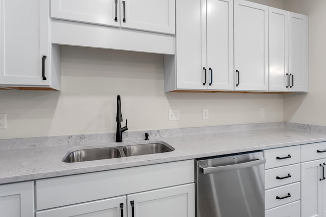 kitchen featuring light stone countertops, sink, white cabinetry, and dishwasher