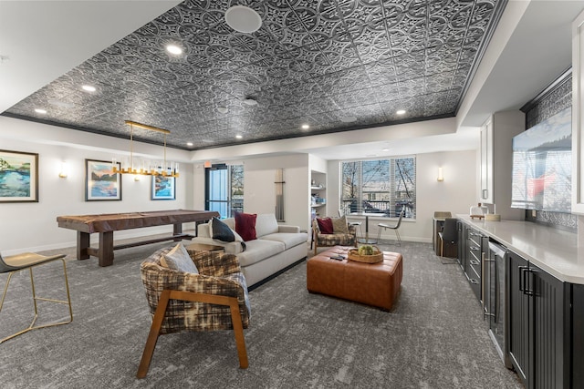 living room featuring pool table, a tray ceiling, dark carpet, and plenty of natural light