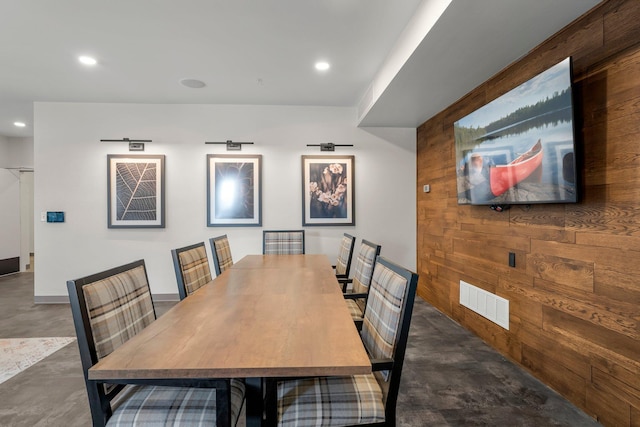 dining room featuring wooden walls