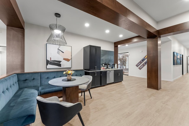 interior space with dishwasher, light hardwood / wood-style flooring, and pendant lighting