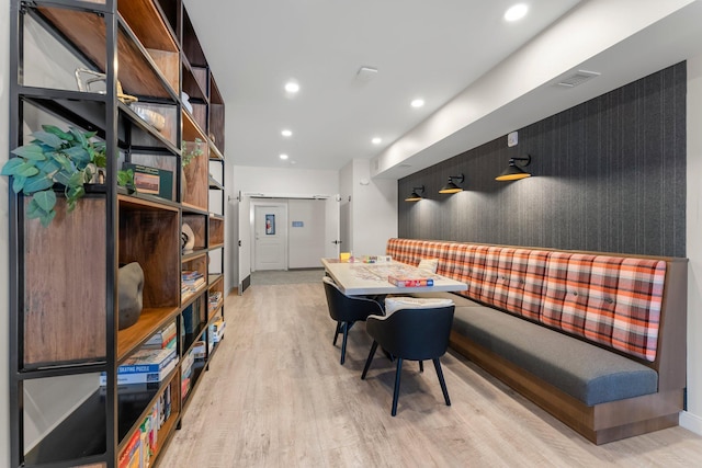 dining room with light hardwood / wood-style flooring and a barn door