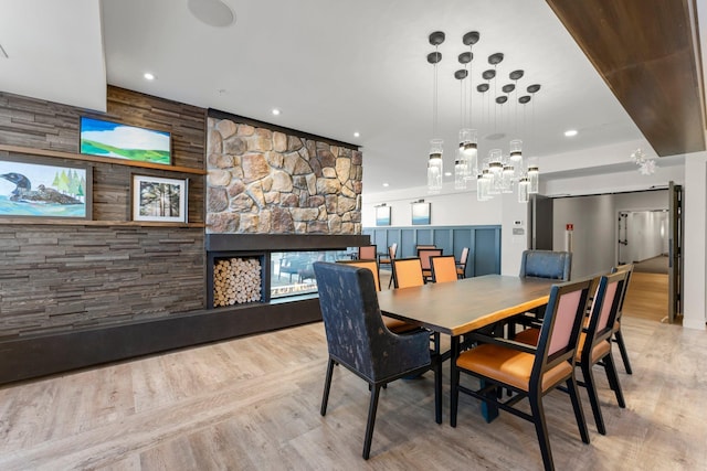 dining space featuring a stone fireplace