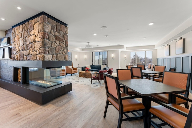 interior space featuring light hardwood / wood-style flooring and a stone fireplace