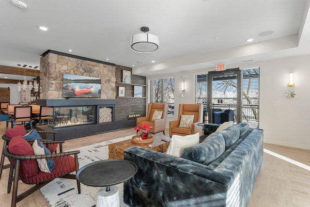 living room with light wood-type flooring and a fireplace