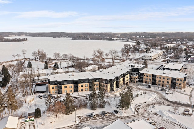 snowy aerial view with a water view