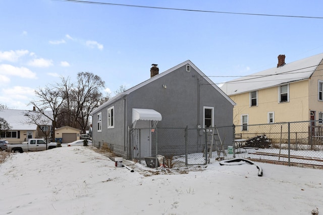 view of snow covered back of property