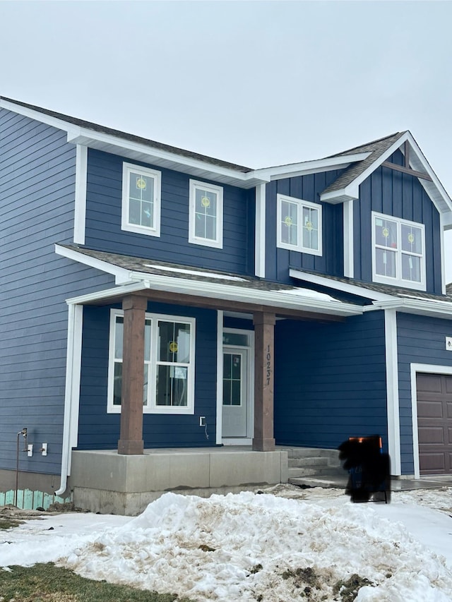 view of front facade featuring a garage and a porch