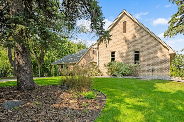 view of side of home featuring a yard