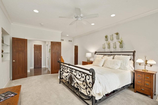 bedroom featuring ceiling fan, ornamental molding, and carpet floors