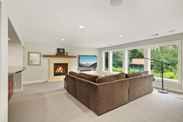 living room with a healthy amount of sunlight and light colored carpet